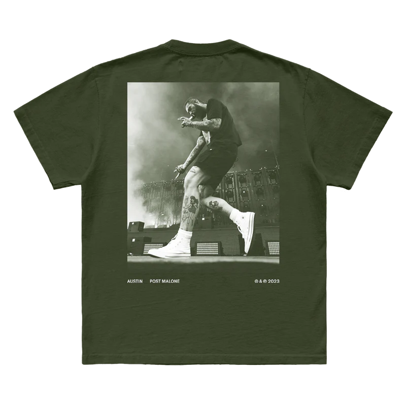 "Olive green t-shirt featuring a black and white image of Post Malone performing on stage, with 'Austin Post Malone © & ℗ 2023' printed at the bottom."