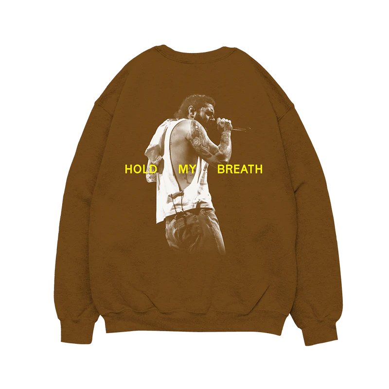 "Brown crewneck sweatshirt with text 'Austin Post Malone © & ℗ 2023' printed in yellow on the front."