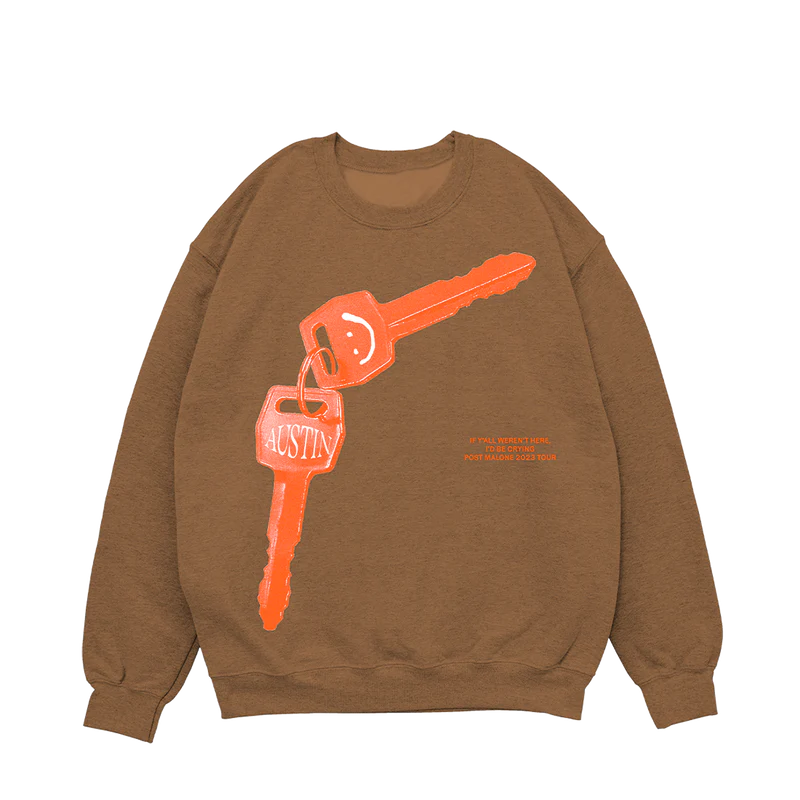 "Tan crewneck sweatshirt featuring a large orange key graphic with the word 'Austin' and a smiley face keychain, along with text 'If y'all weren't here, I'd be crying. Post Malone © 2023 Tour' in orange."